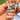 Couronne de Sirène blue mermaid seashell nails worn on a hand in a medium almond shape, featuring nude and blush-pink tones, aqua-blue accents and raised shell-like 3D details.