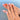 Summer Fruit Medley short almond nails worn on a hand with colorful fruit-inspired details.