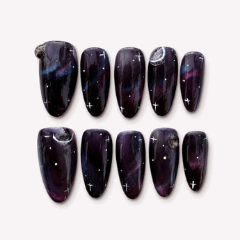 Celestial Mystery cat eye galaxy nails with deep purple tones, crescent moons and star details.