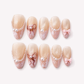 Pearl Lace Bow wedding nails with pearls, blush lace tips and soft pink 3D bows.