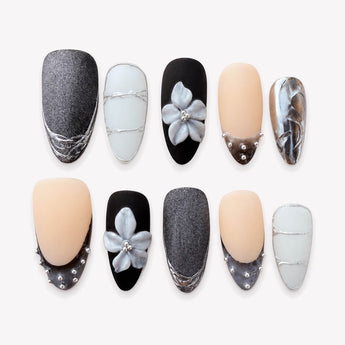 Modern Eveningwear black chrome nails with silver accents, raised florals and clear details.