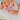 Model-hand view of Ladybug Toadstool Daydream cute short almond nails with red French tips and ladybug details.