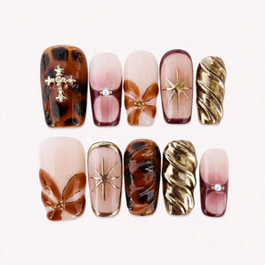 Amber Eclipse 3D chrome nails with amber-brown marbling and raised floral accents
