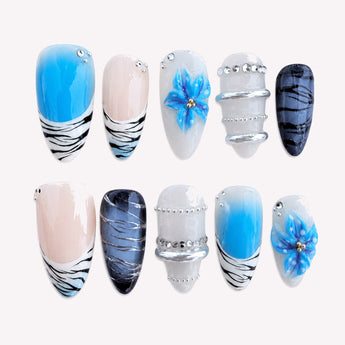 Cobalt Bloom zebra french tip nails with electric blue gradients, orchid-like flowers and silver accents
