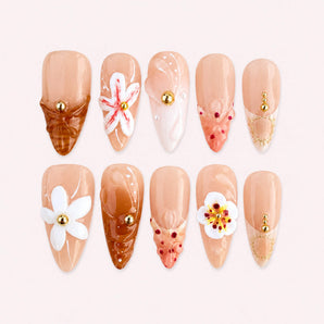 Amber Petal Veil white flower nails in peach nude with raised blooms and translucent amber accents.