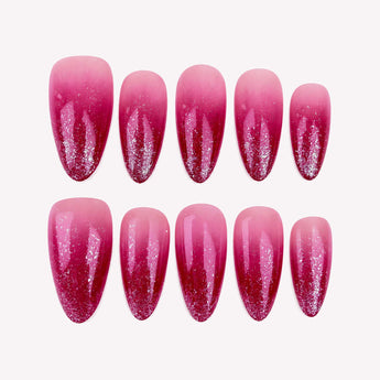 Rosy Afterglow red ombre nails with a soft pink fade, fine silver-looking sparkle and almond tips.