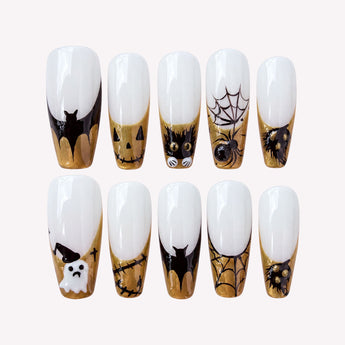 Boo & Behold Halloween French tip nails with a milky white base, gold shimmer, black cats, bats, and spiderwebs.