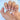 First Blush press-on nails featuring a short almond shape, white smile lines, and a softly shimmering nude base.