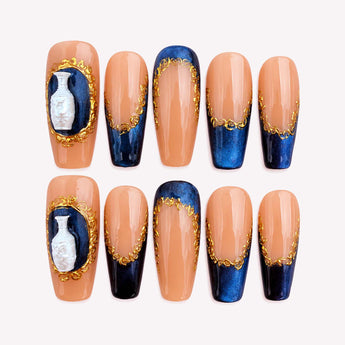 Royal Keepsake press-on nails with a nude base, blue chrome-like French tips, and raised white vase accents