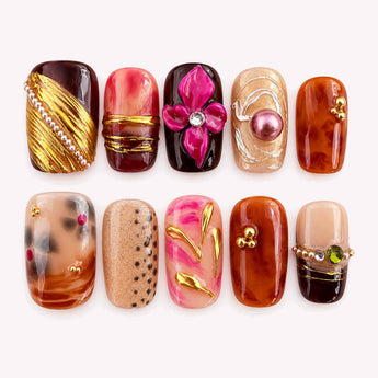 Grand Gesture short squoval press-on nails with a raised magenta flower, gold-tone accents, and a pearl-like bead
