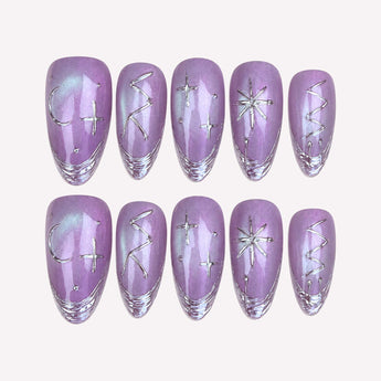 Moonlit Lilac purple cat eye nails with silver crescent moons, starbursts and layered silver tips, shown in medium almond.
