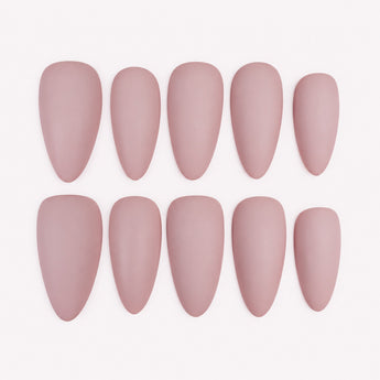 Rose Hush solid color almond nails in muted blush pink with a matte appearance, shown in a short length.