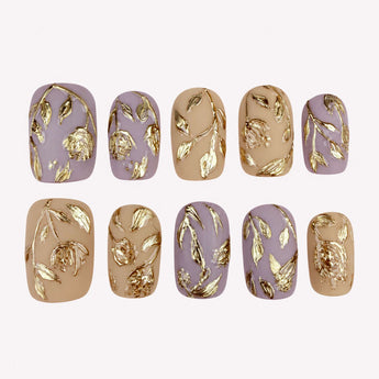 Gilded Garden press on nails with raised gold-toned flowers on lavender-mauve and taupe-beige bases.