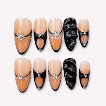 Cygne de Minuit black French tip press on nails with a sheer nude base, sculptural black 3D accents and silver-tone jewel-like details.