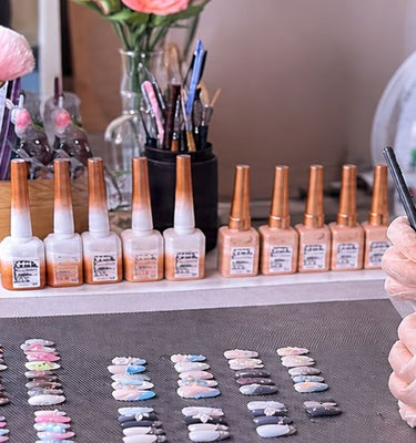Nail artists handcrafting handmade press on nails with detailed designs at Auranailed studio