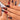 Obsidian Vein long stiletto red and black ombre nails worn on a hand with raised black 3D textures, gold-tone crack-like accents and a glossy finish.