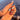 Tropical Clownfish cute tropical nails worn on a hand in a short almond shape with aqua blue fish-inspired details.