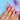 Model hand view of Girly Party Glam pink French tip press-on nails in a medium stiletto shape.