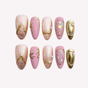 Rose Gilded Keepsake rose gold chrome nails with blush-pink tones, pearl-like accents and gold framing.