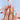Model-hand view of Duckling Bubble Dream cute holiday nails with pastel duckling, bow and bubble-like accents.