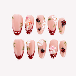 Ladybug Toadstool Daydream cute ladybug nails with raised mushrooms, white petals and red dotted French tips.