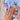 Model-hand view of Lagoon Bloom aqua jelly nails with clear 3D droplets, floral accents and flowing blue details.