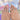Prism Arc Reverie long coffin multicolor French tip nails shown on hand with curved white lines and raised accents