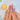 Short almond Color Carousel press-on nails with playful blue, pink, yellow and orange gradients and a glossy finish.