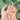 Wild Muse nail design with peach-pink floral details, gold-tone outlines, and translucent wrapped bands