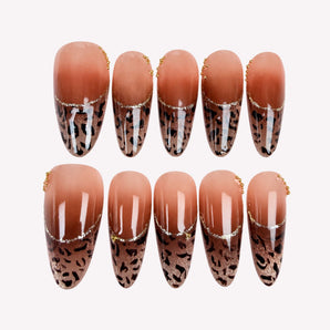Caramel Afterglow leopard print French tip nails with brown ombre and champagne-toned shimmer.